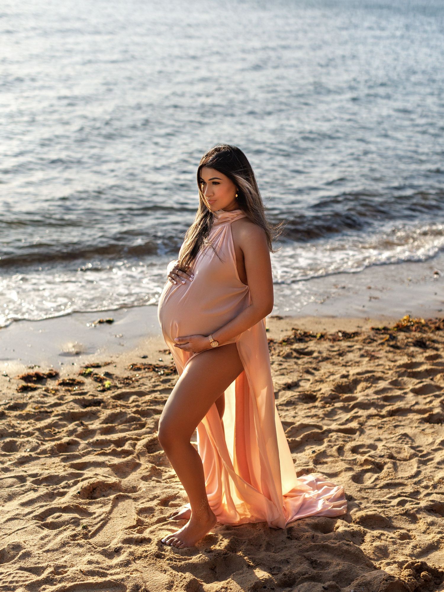 Pregnancy photoshoot highlighting baby bump details
