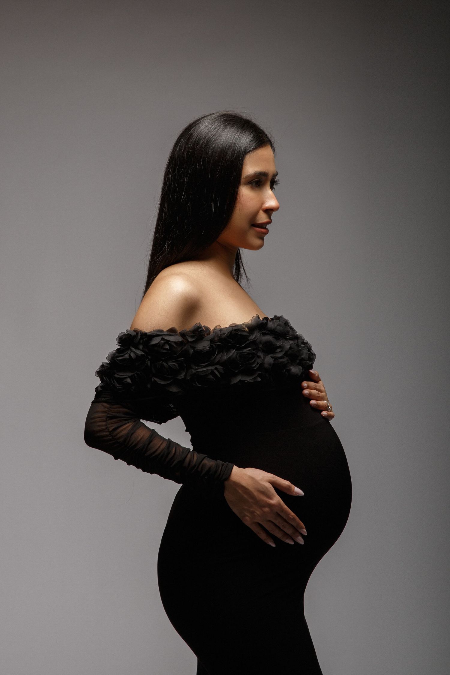 Professional maternity portrait photographed with studio lighting