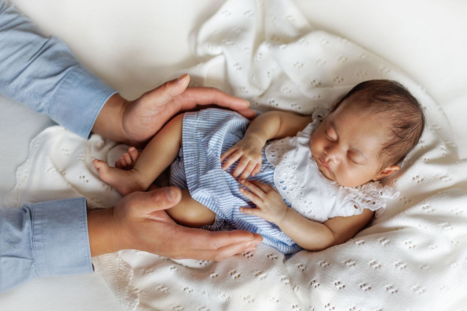 Studio newborn photography highlighting tiny baby details