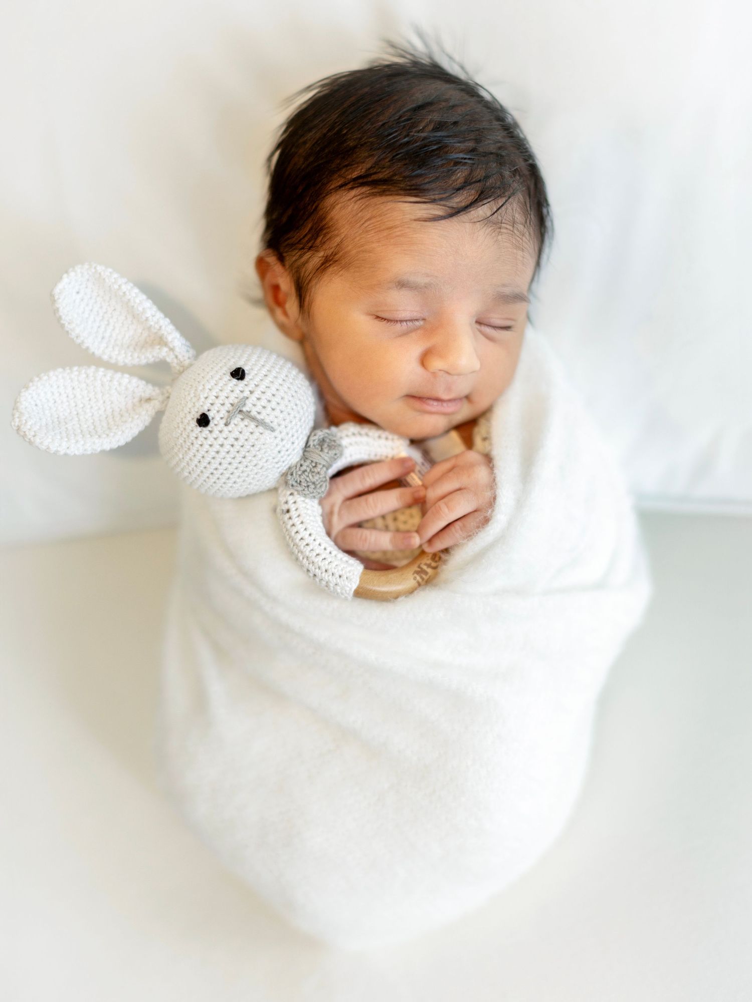 Newborn photography portrait featuring a peaceful newborn
