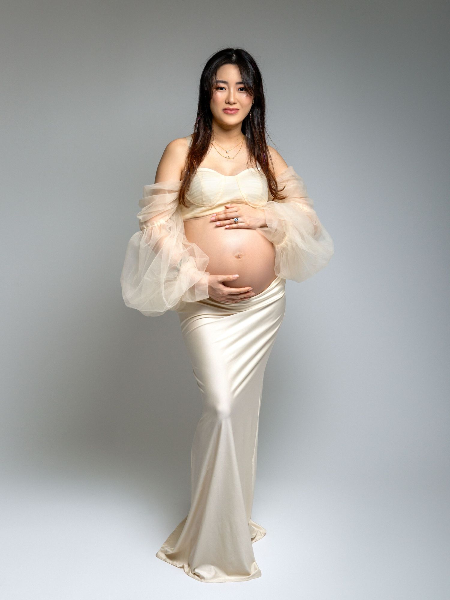 Studio maternity photoshoot with elegant styling and lighting