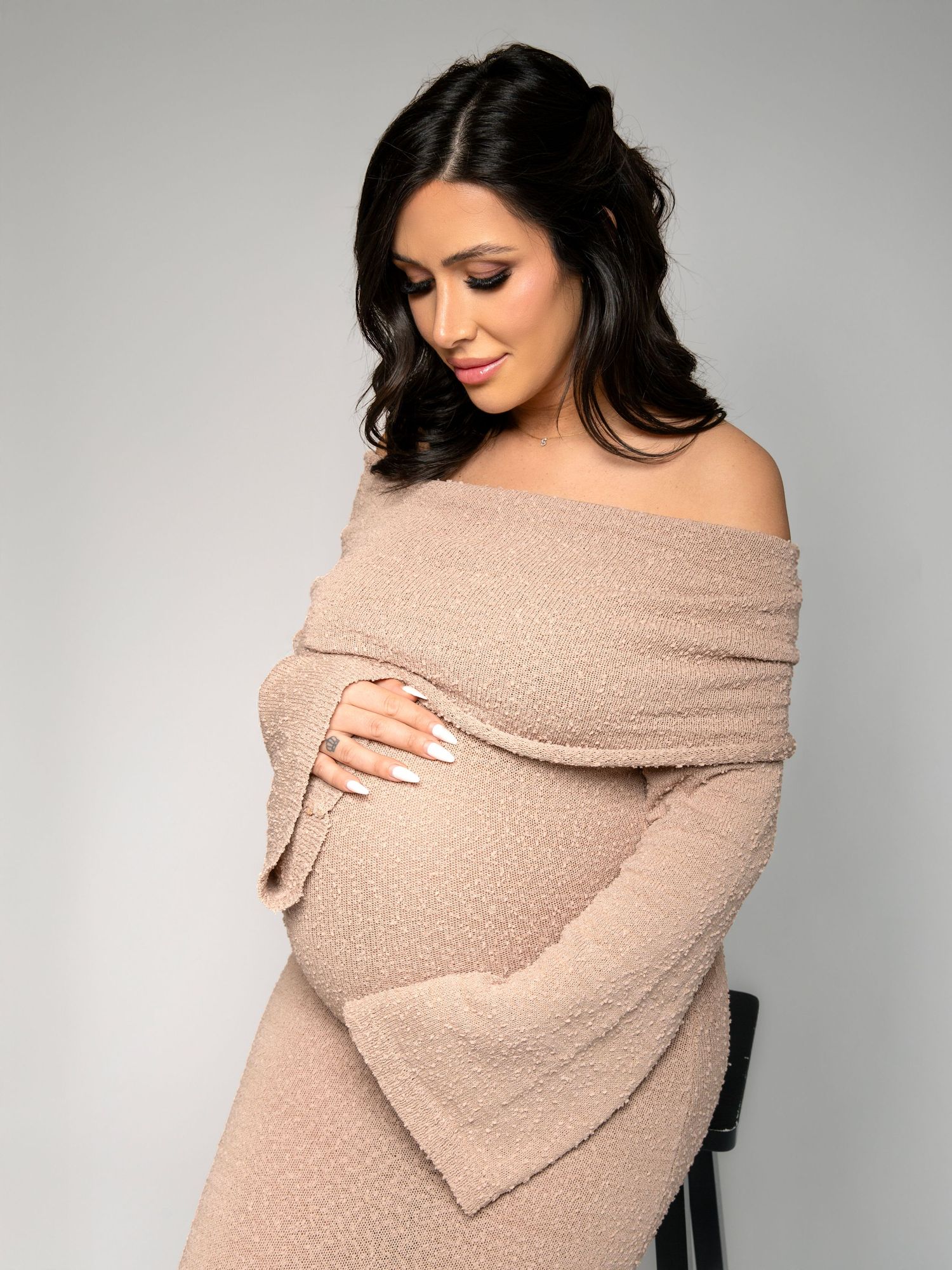 Minimalist studio maternity photography with soft fabrics