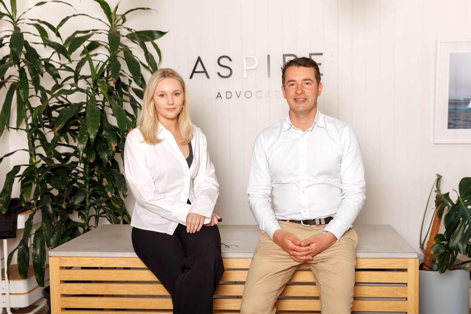 Professional team portrait in a modern office setting, showcasing confident business people in a clean, natural workspace.