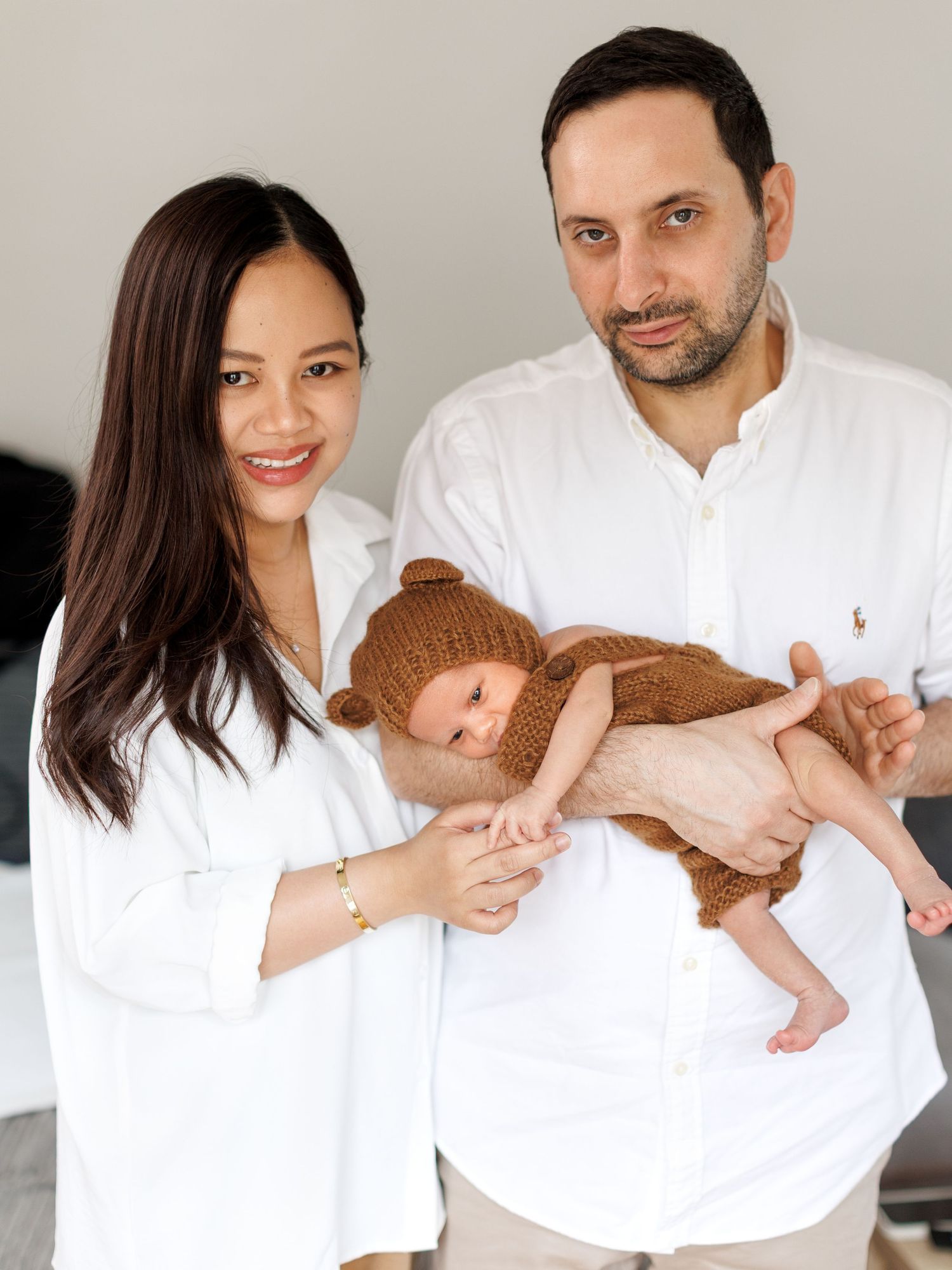 Newborn photography portrait featuring a relaxed baby pose