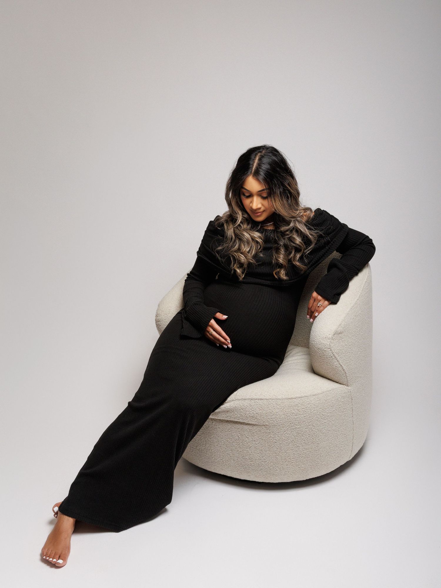 Studio pregnancy photography session using controlled studio lighting