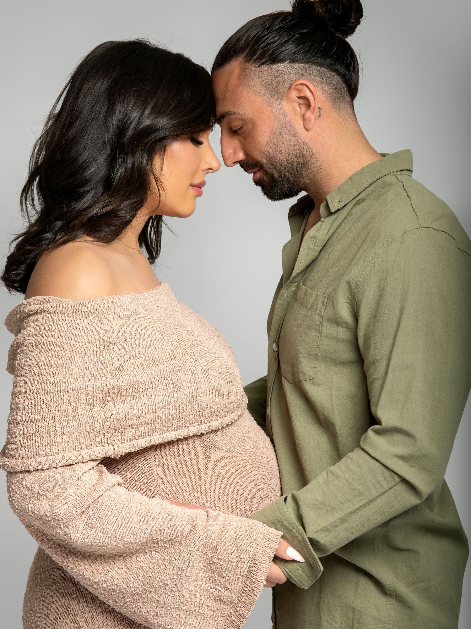Maternity photography session in a clean, neutral studio environment