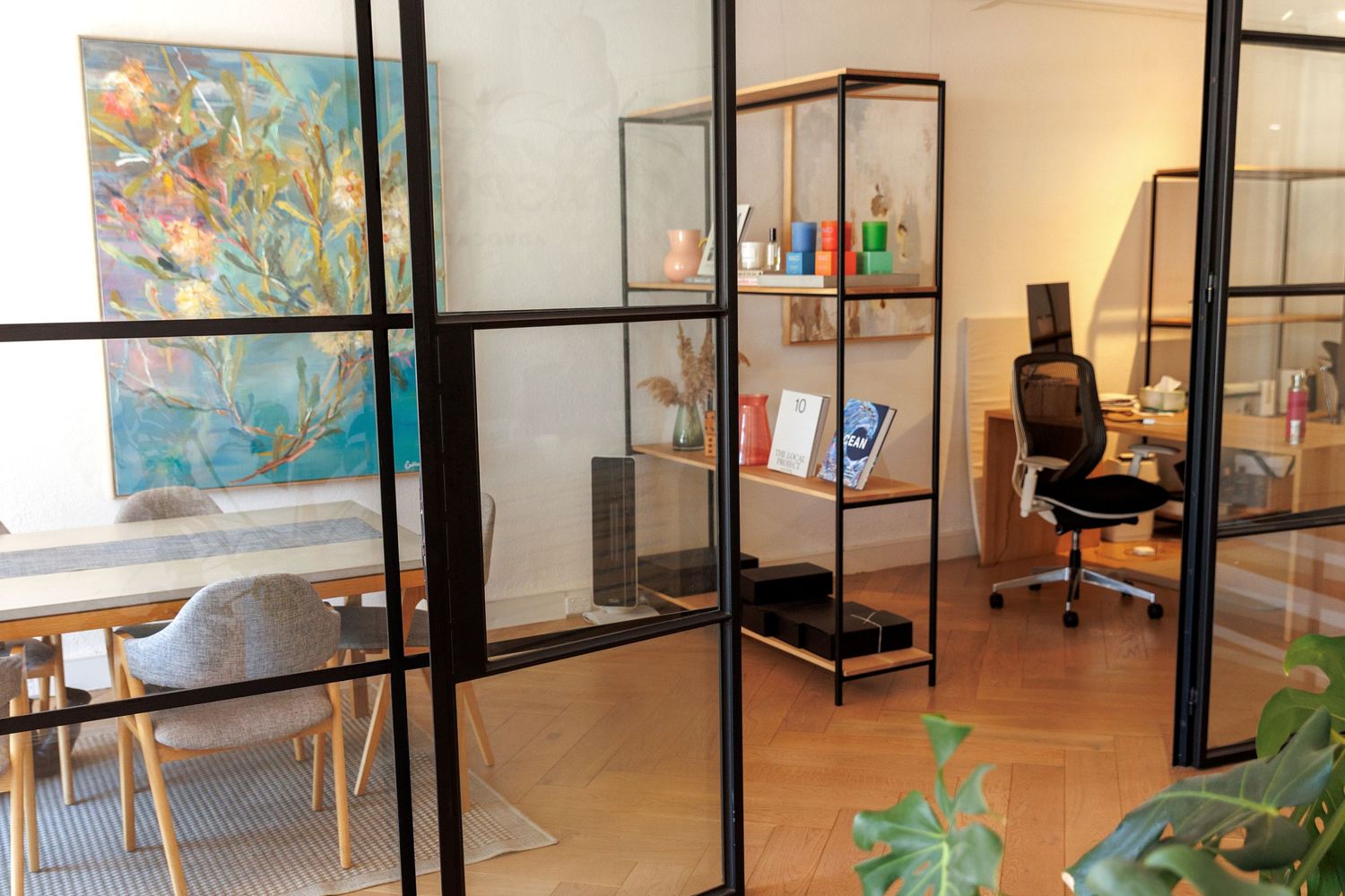 Professional team portrait in a modern office setting, showcasing confident business people in a clean, natural workspace.