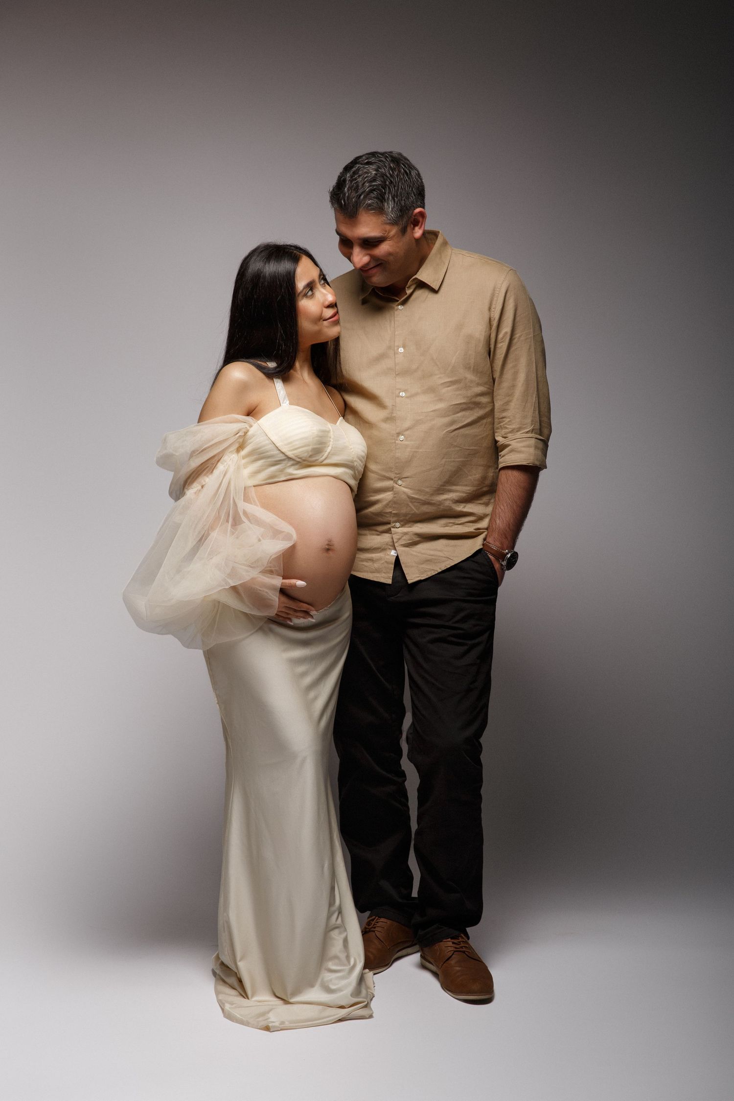 Studio maternity photography session using soft, flattering lighting