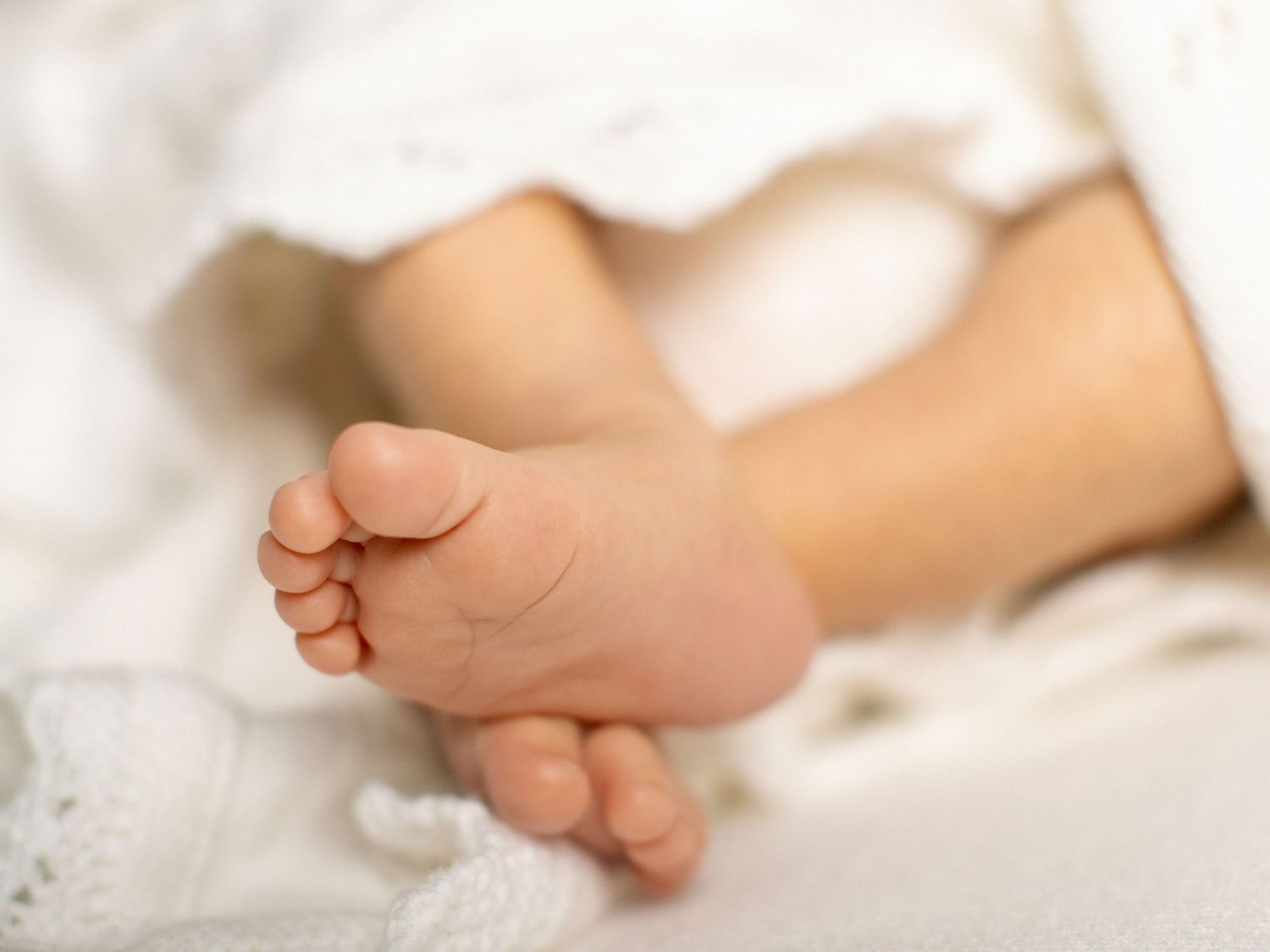 Newborn photography portrait with soft textures and light