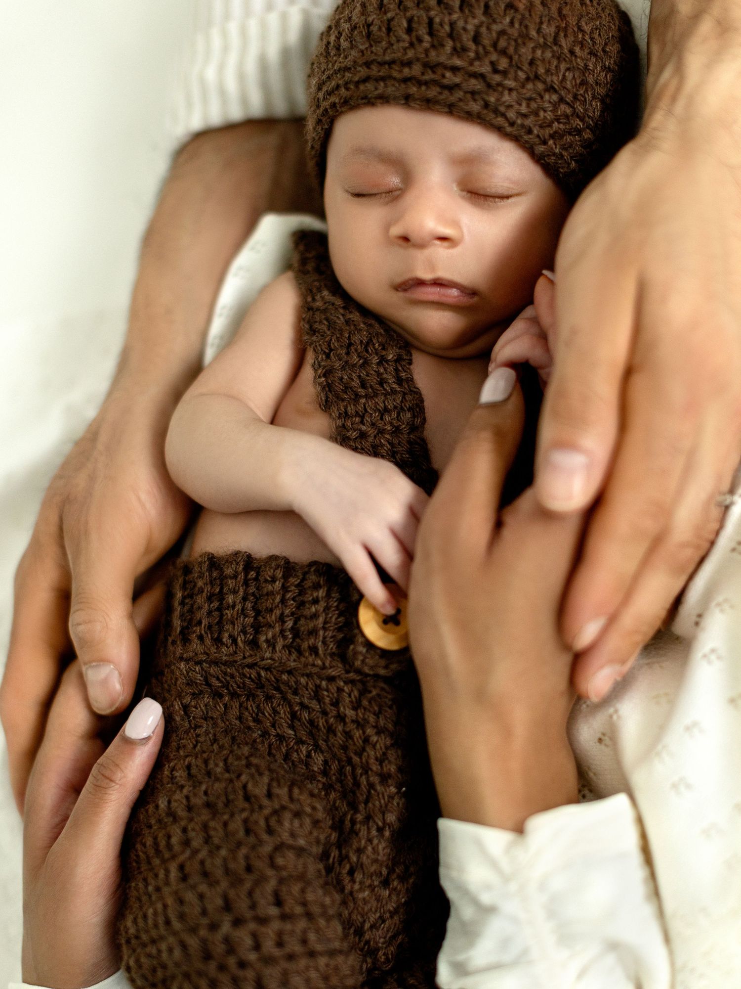 Studio newborn photography with soft light and neutral styling