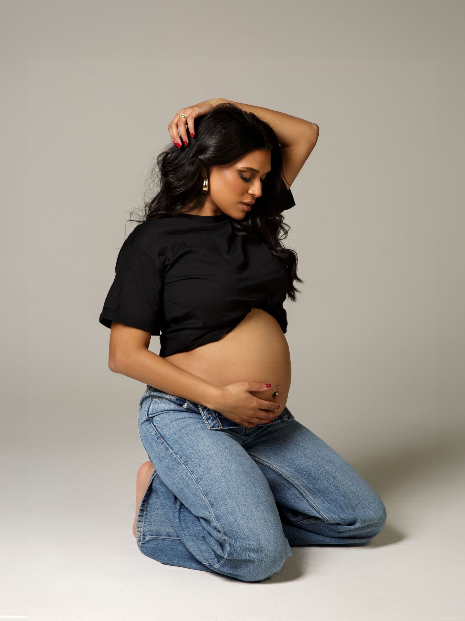 Maternity photography session in a studio with carefully styled lighting