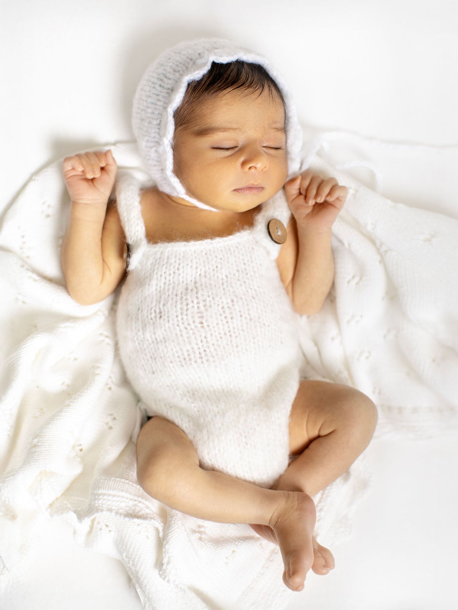Studio newborn photoshoot capturing a sleeping baby