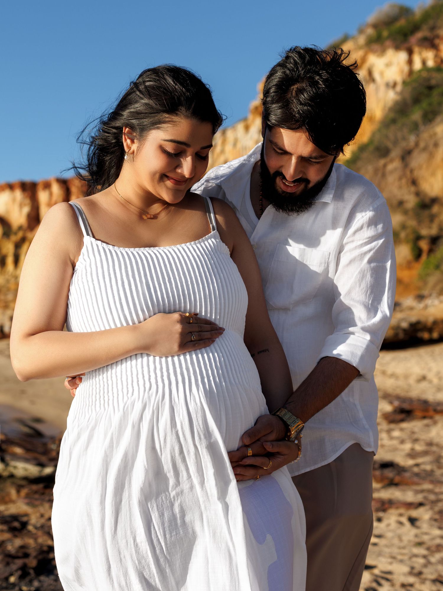 Beach maternity session with a couple expecting a baby