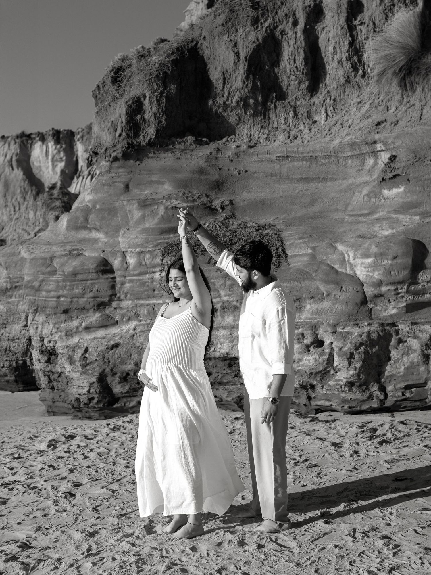 Pregnancy photoshoot on a sandy beach at sunset