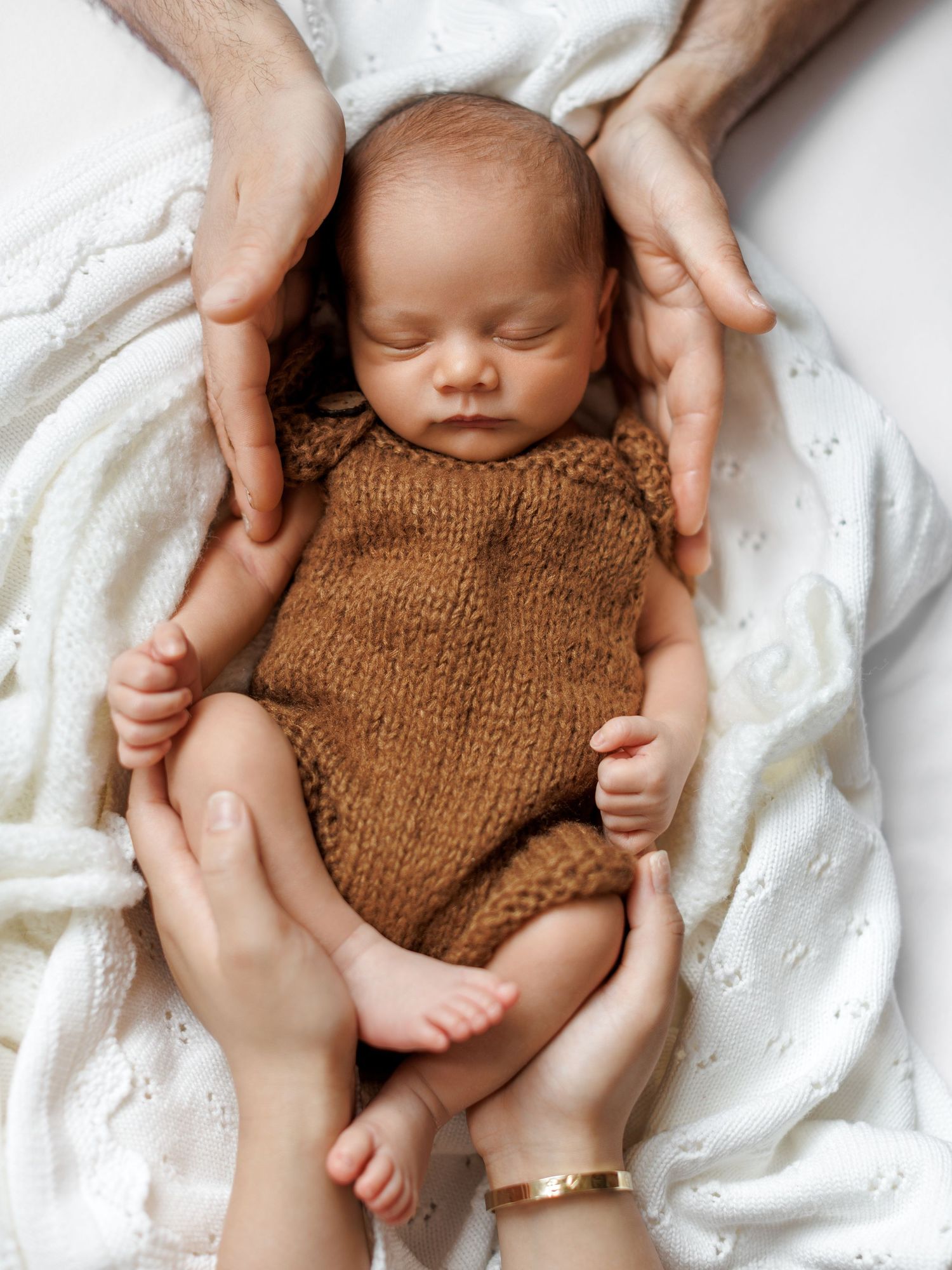 Studio newborn photography capturing a peaceful sleeping baby