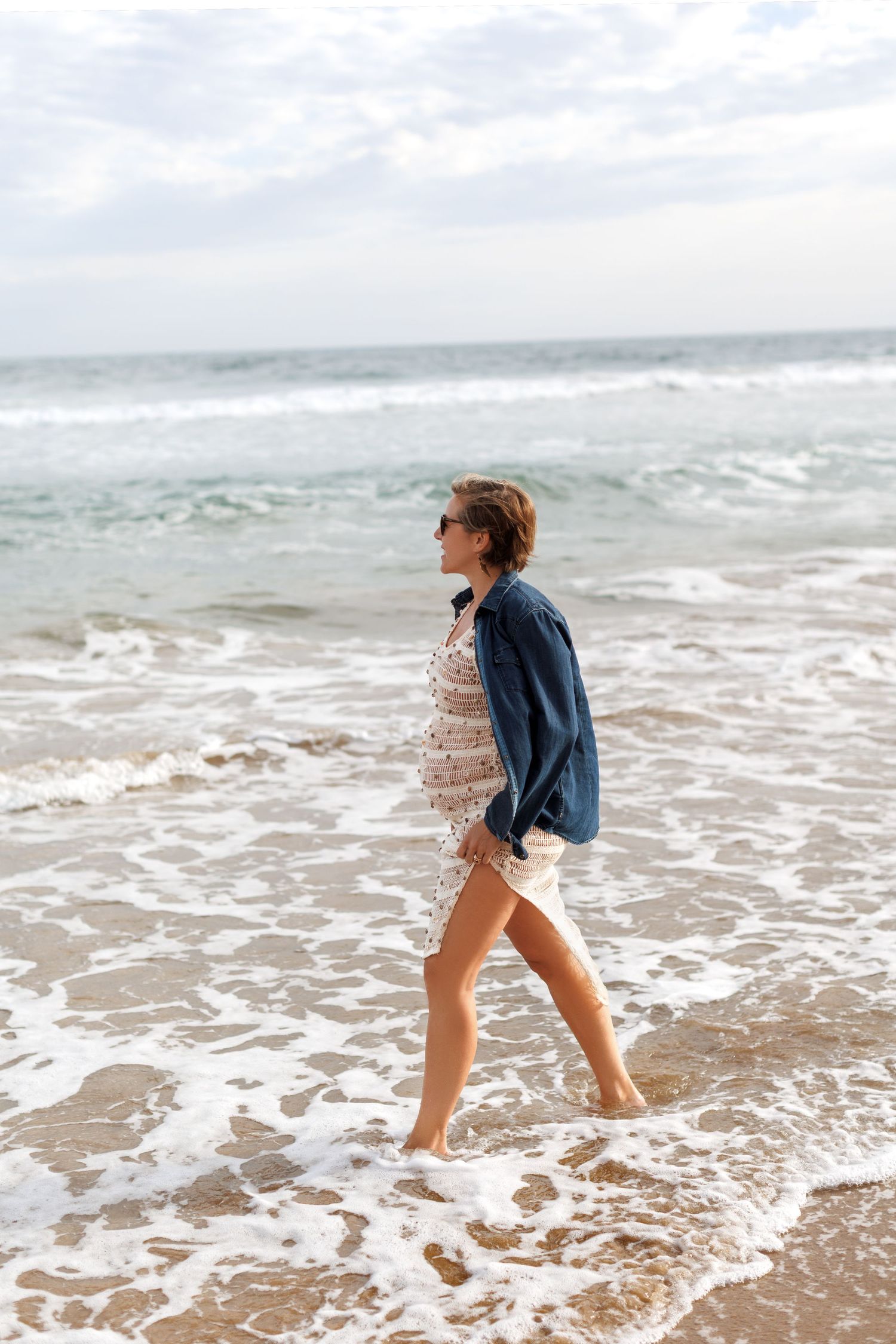 Beach maternity photoshoot with soft light and coastal scenery