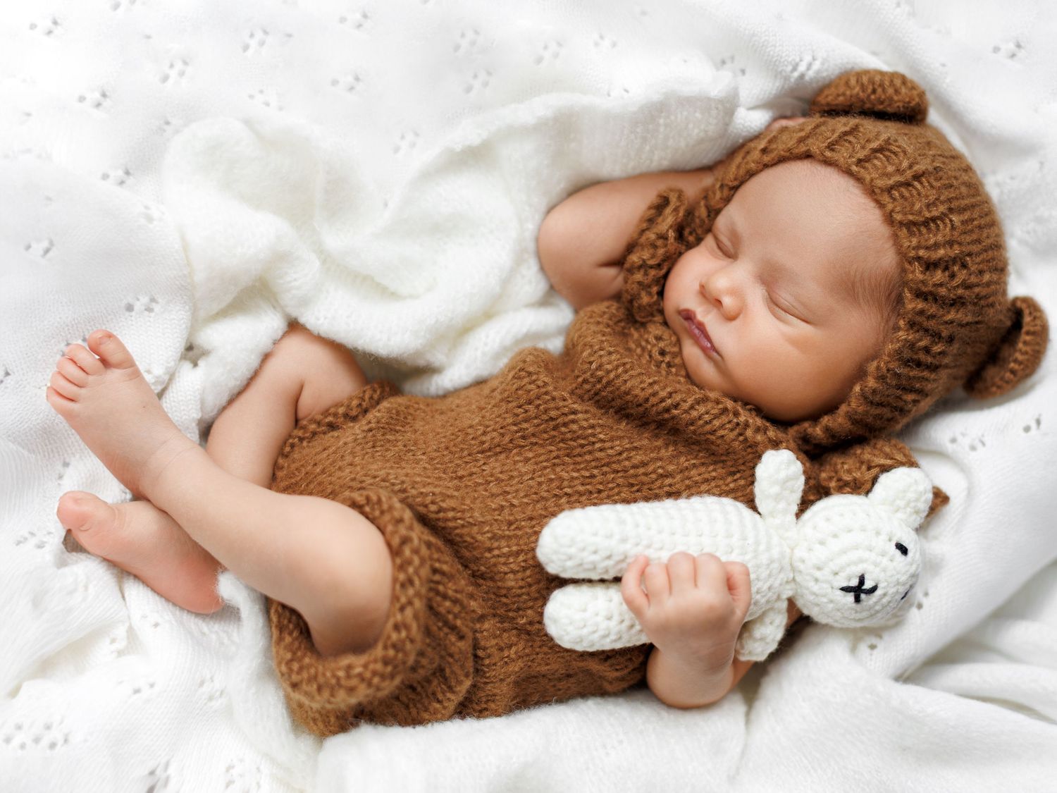 Newborn photography session with a baby in a cosy studio environment