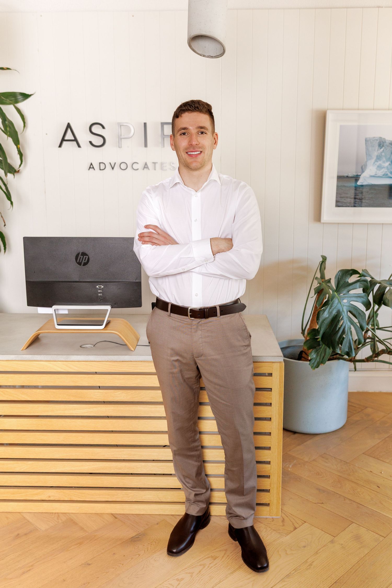 Professional team portrait in a modern office setting, showcasing confident business people in a clean, natural workspace.