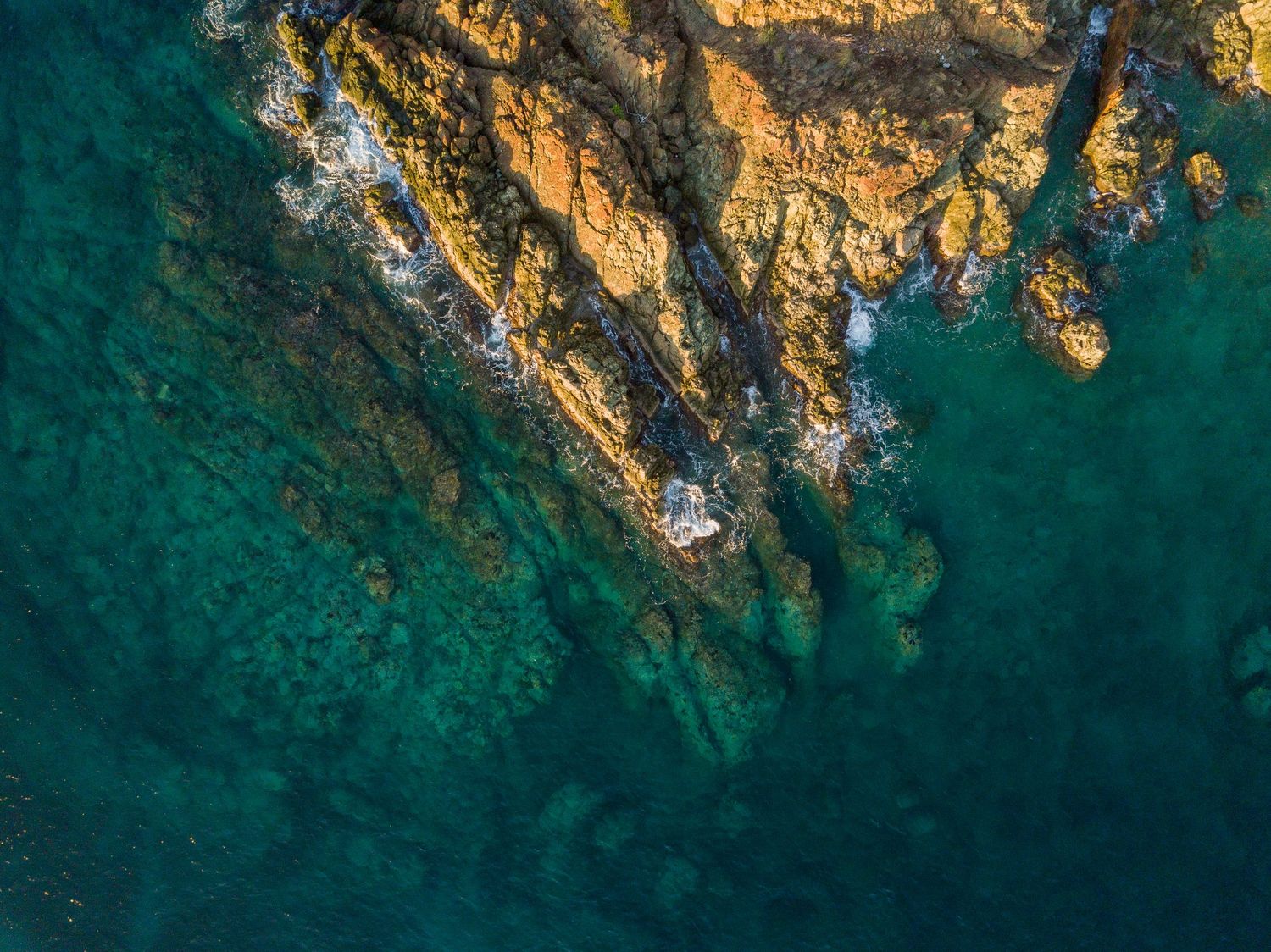 waves crashing on rocks in British Virgin Islands - drone point of view