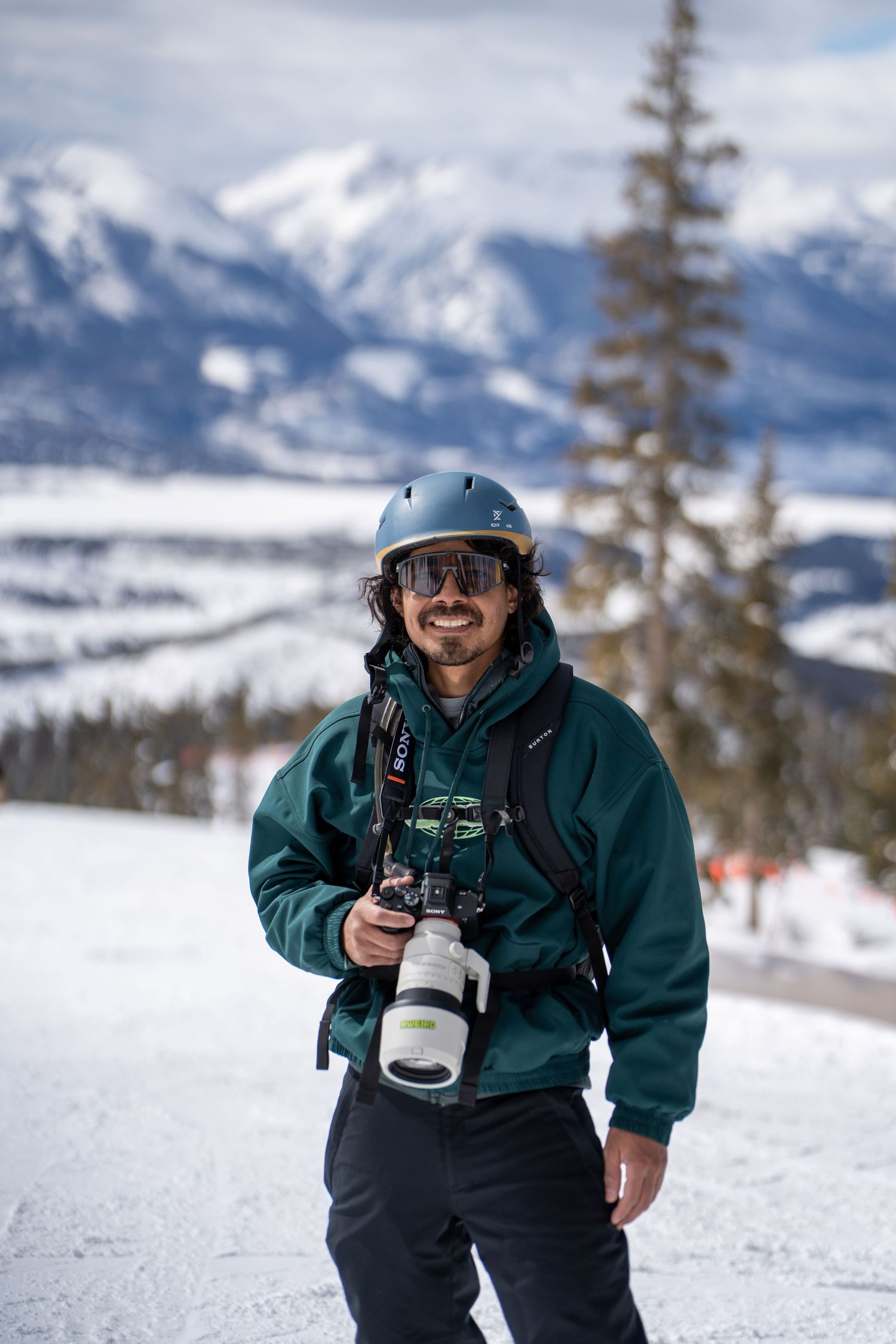 portrait photo of man holding a camera in the winter