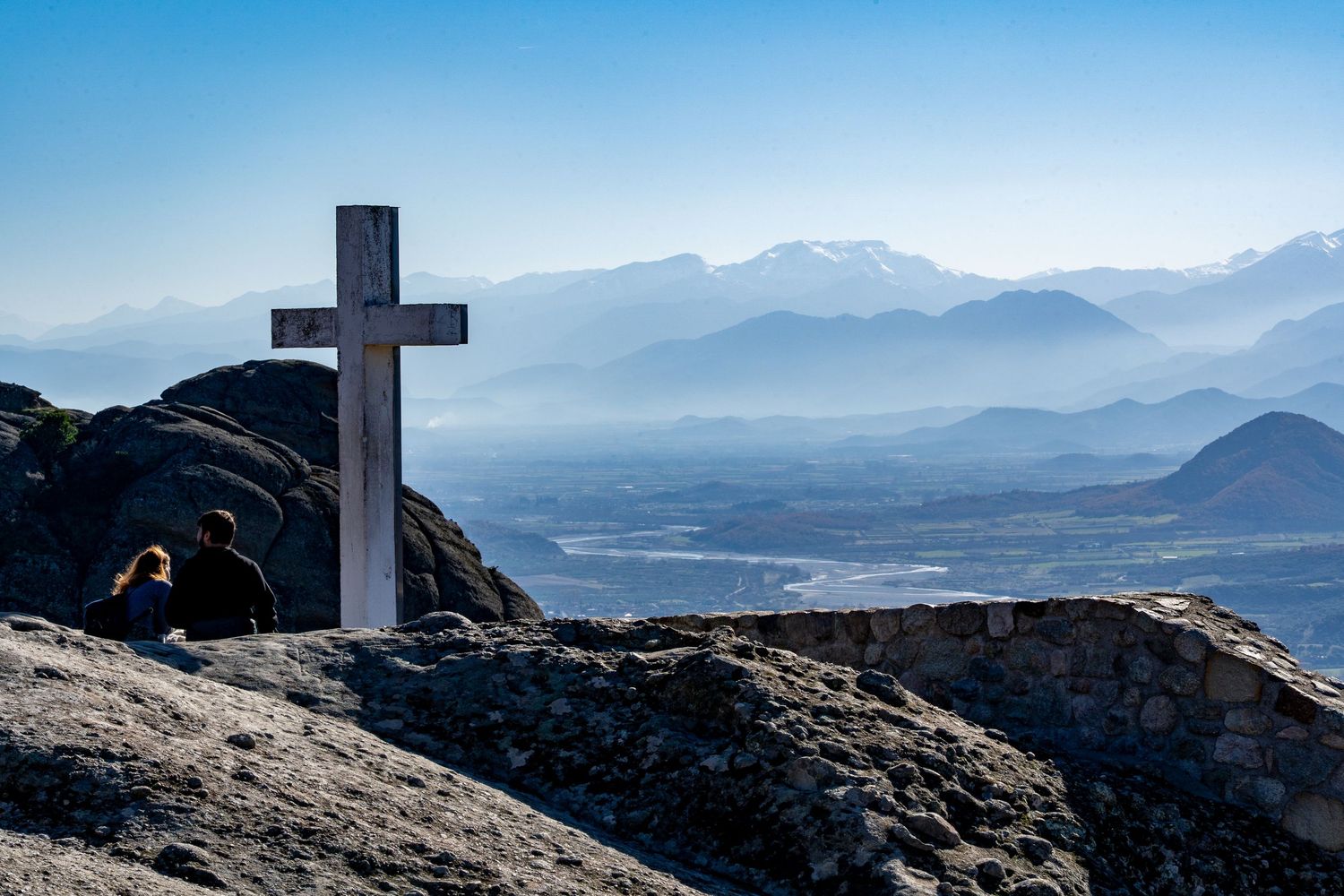 cross overlooking mountains in Greece outside of athens