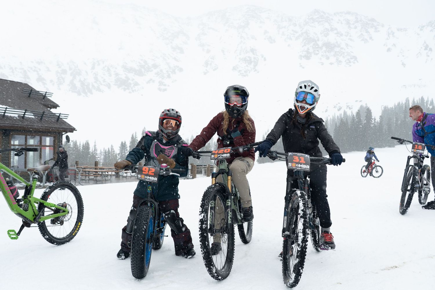 ski bikers at arapahoe basin smiling