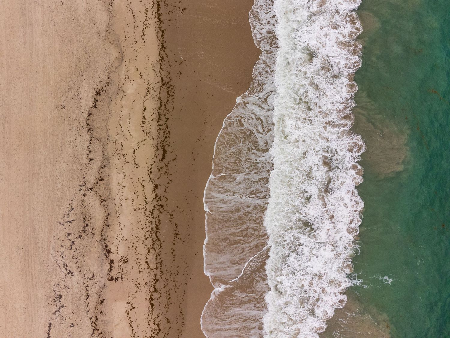 Waves crashing on beach in Florida drone shot