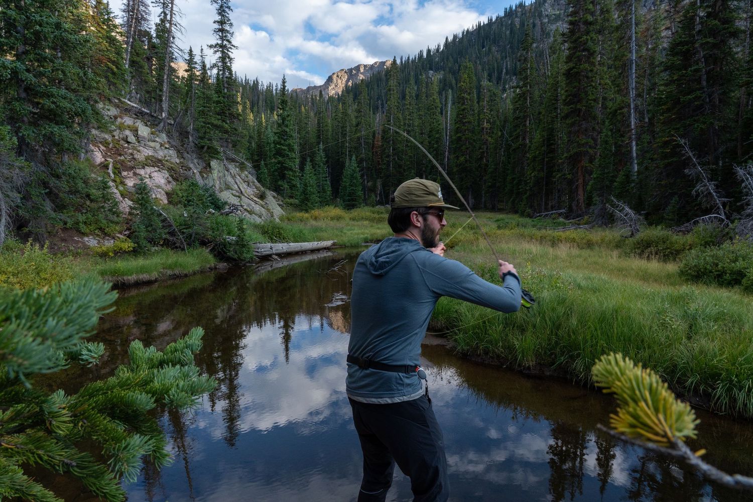 man fishing in piney creek in colorado