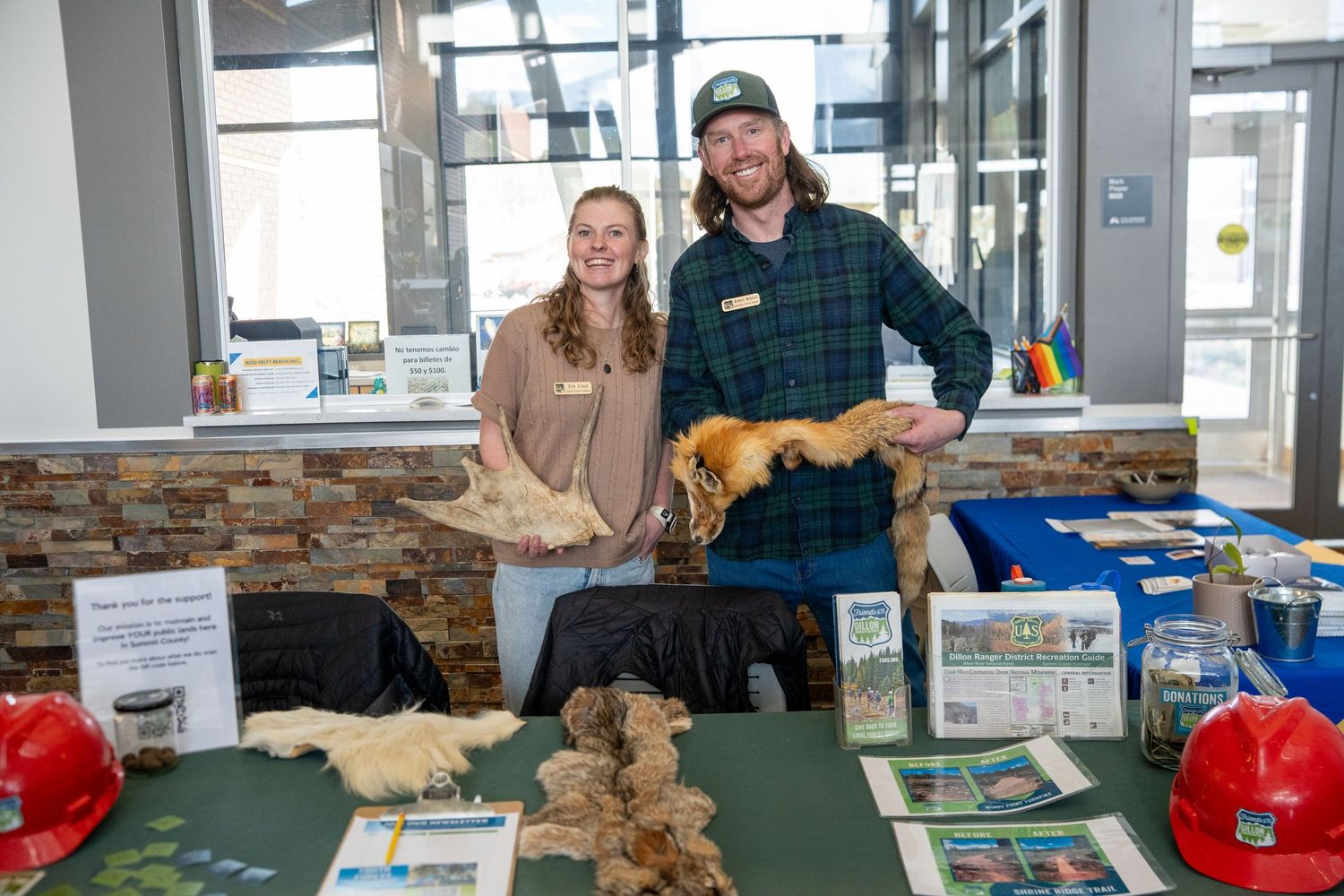 two people posing with animals for dillon co conservation