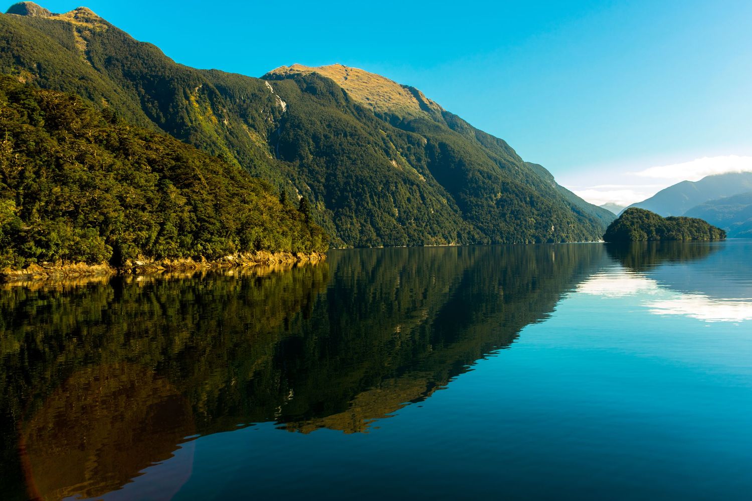 reflective water with mountains and lakes