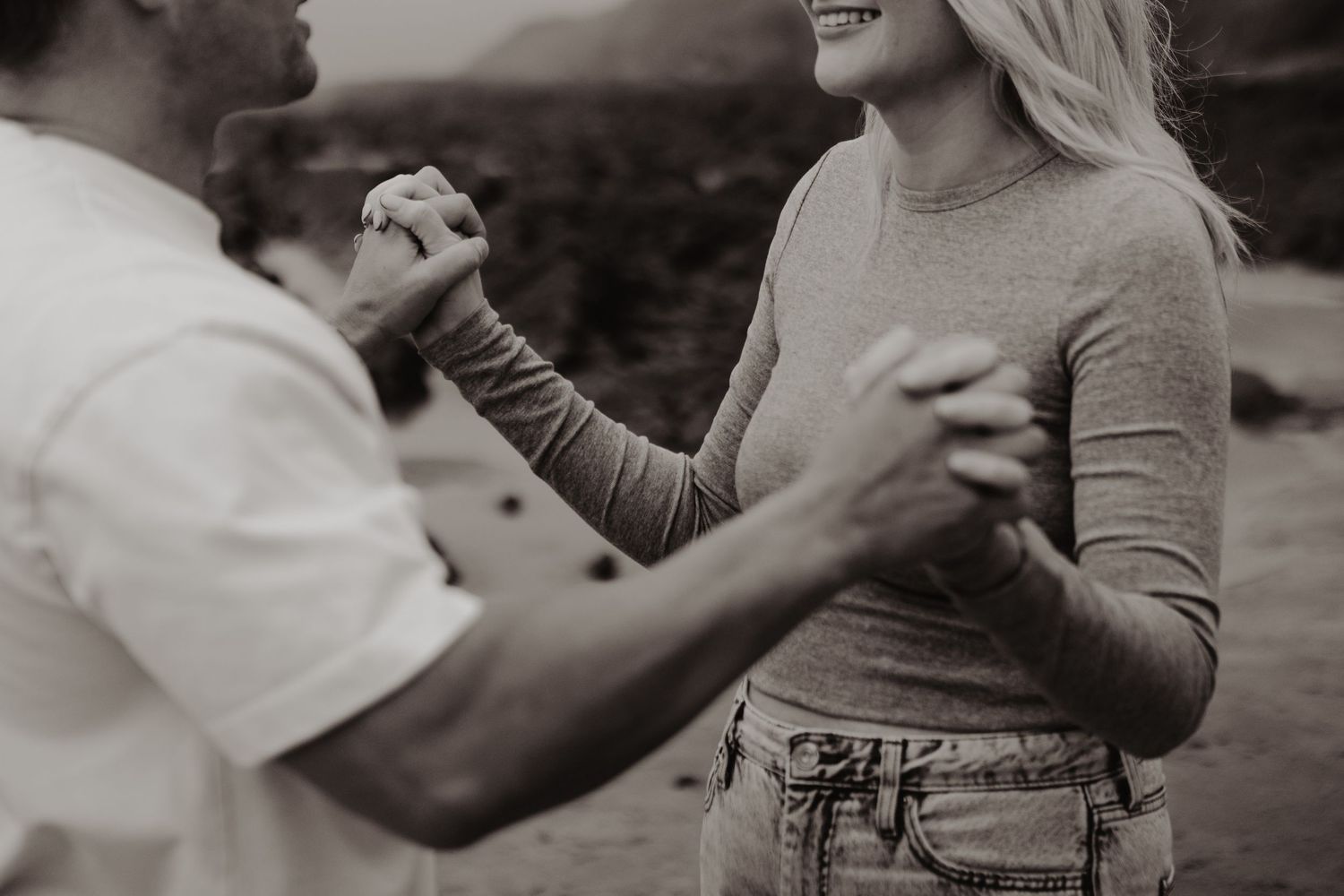 A series of black and white photos showing tender romantic moments between a couple in casual attire.