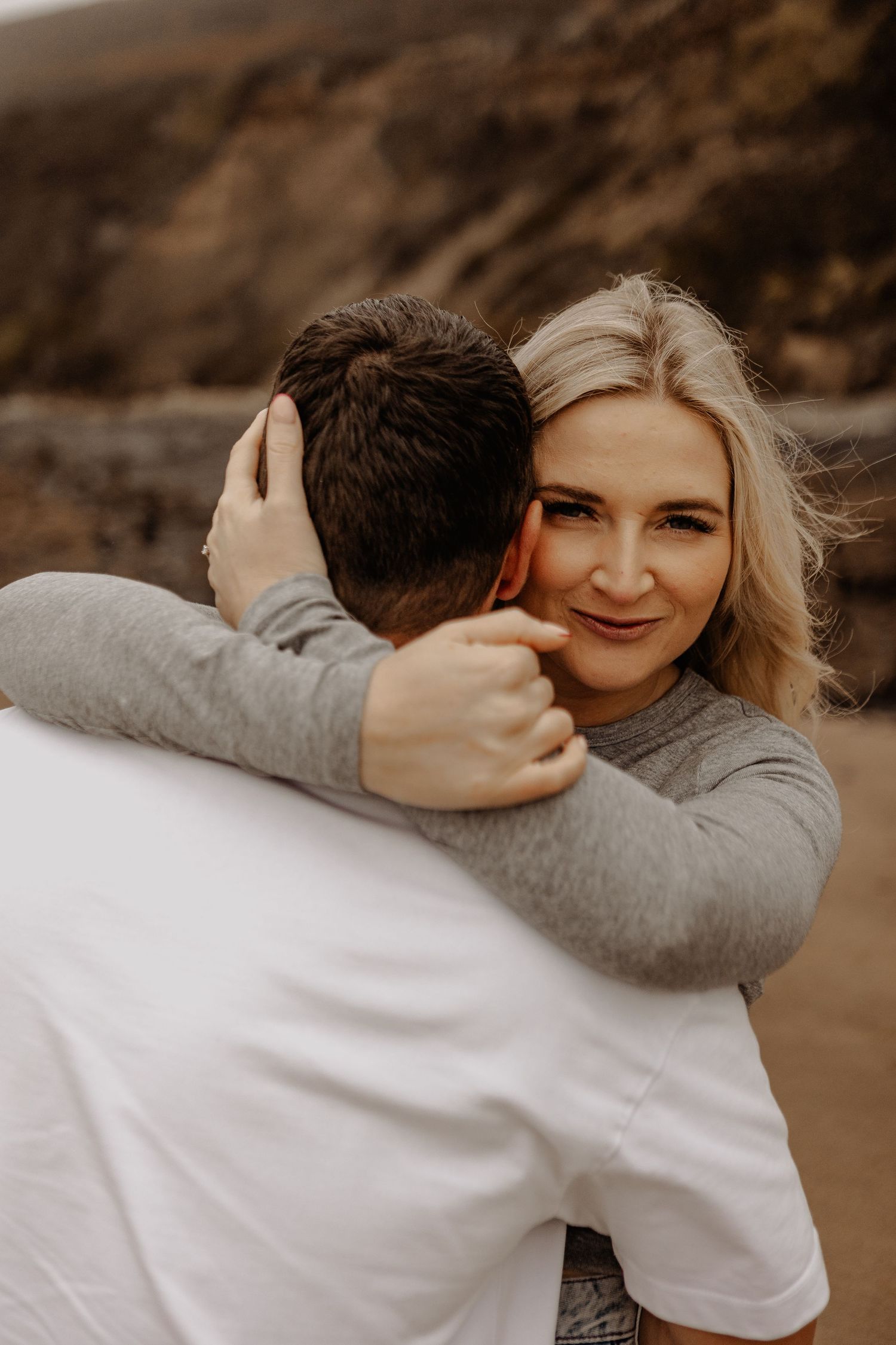 Intimate couple photoshoot with warm sepia tones showing tender moments.