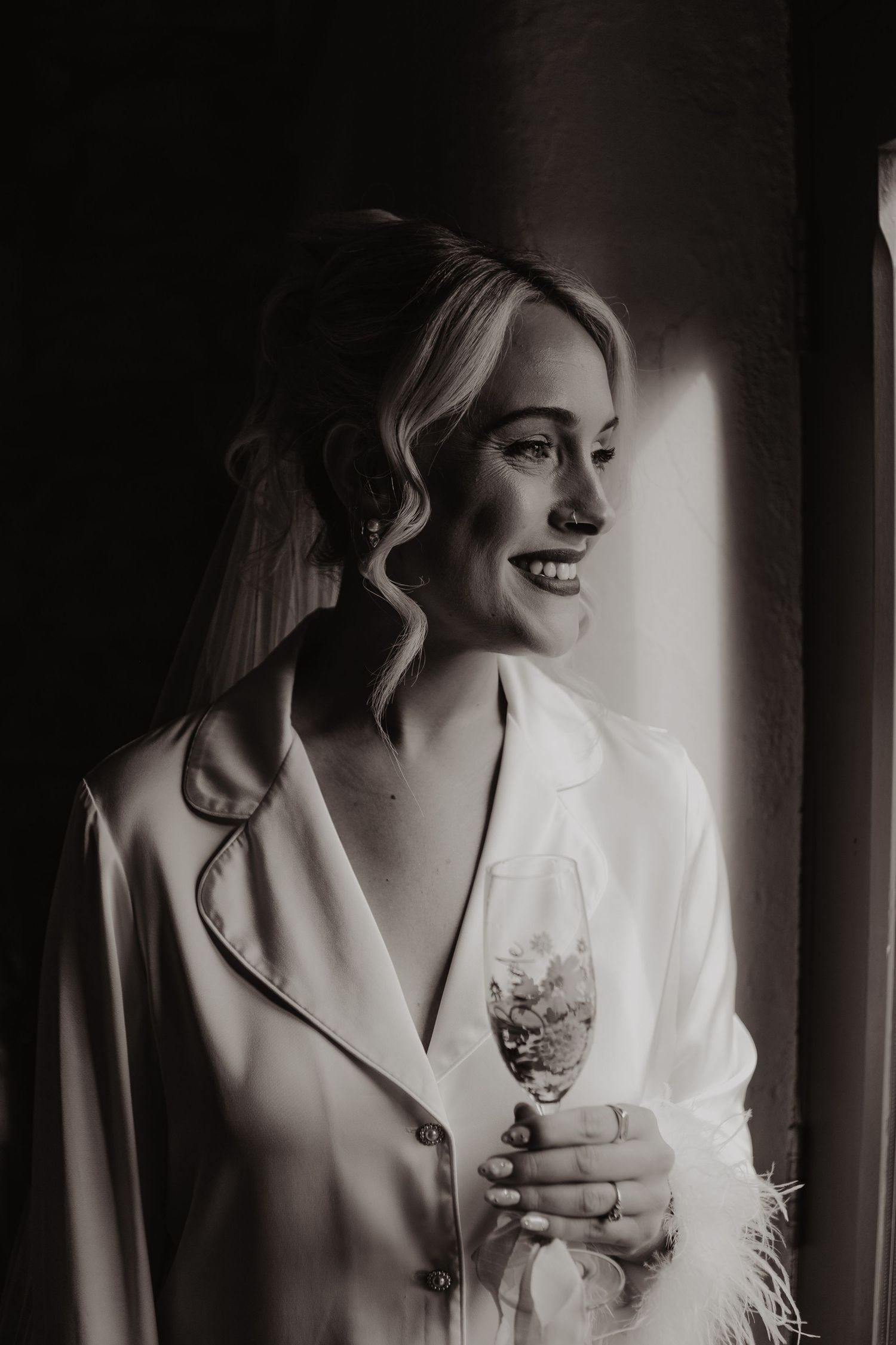 Dramatic black and white boudoir photo series showing a woman in white robe with vintage styling and moody lighting.