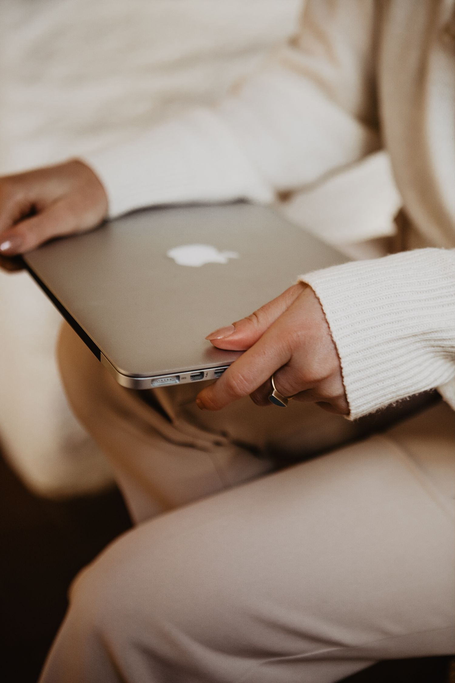 A laptop keyboard and touchpad shown in a series of minimalist close-up shots with hands interacting with the device.