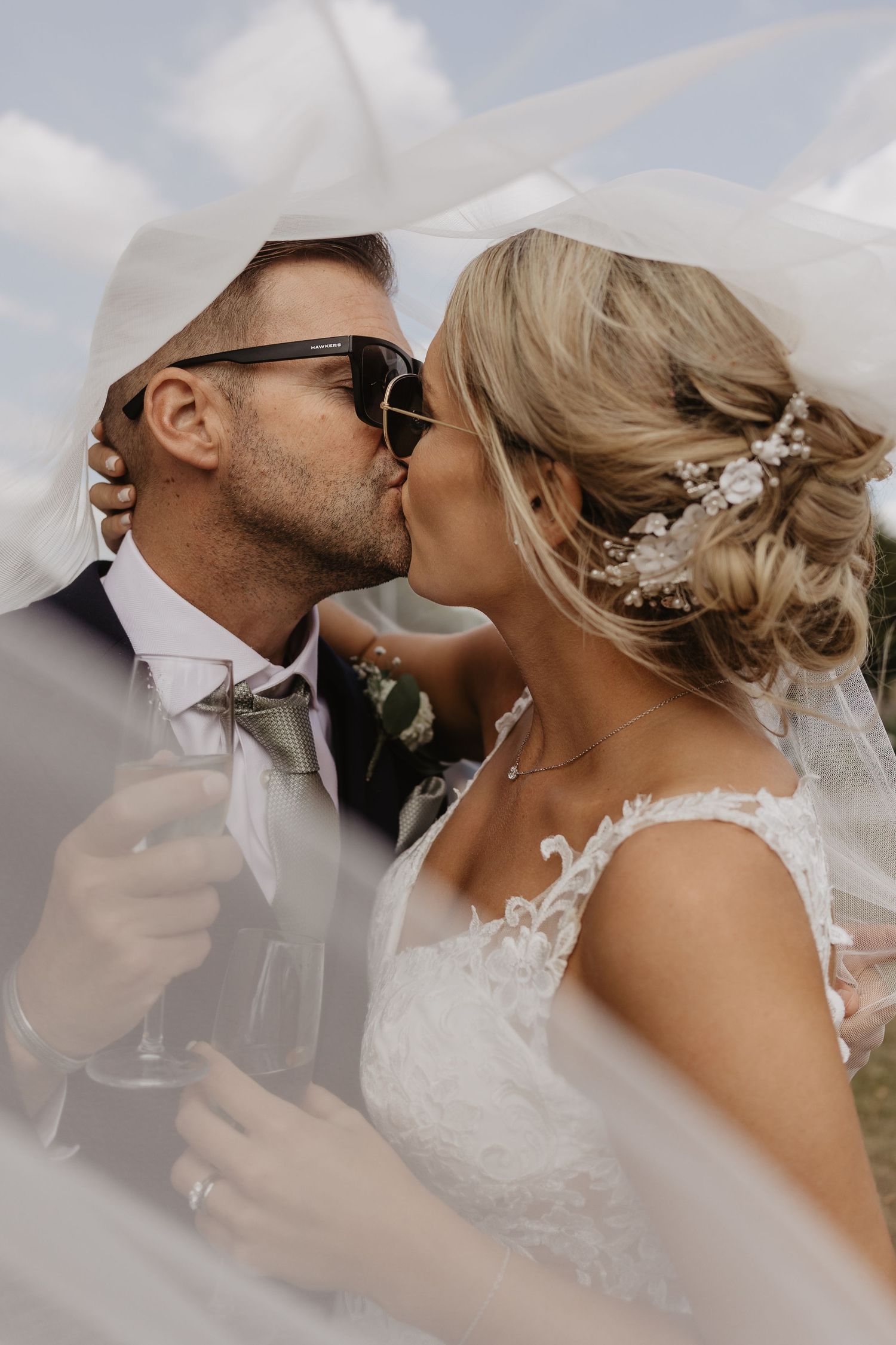 Close-up wedding photography showing intimate moments between newlyweds against a soft background.