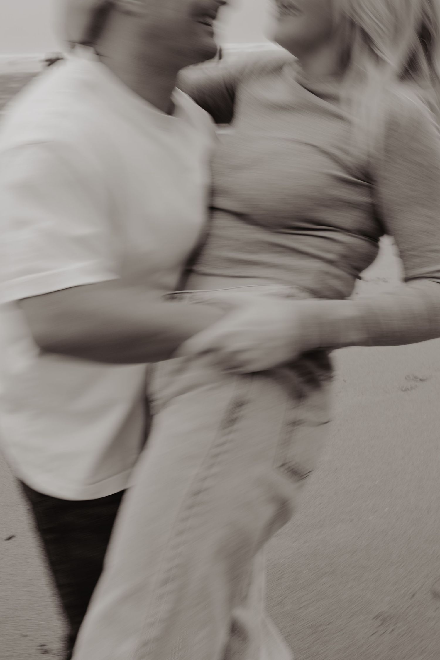 Blurred motion capture of a couple dancing together in casual attire.