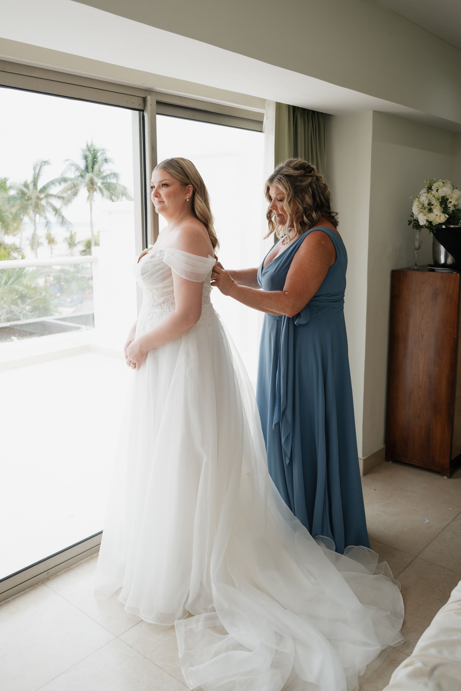 Bride getting on her dress at Sandos Caracol Eco resort Mexico