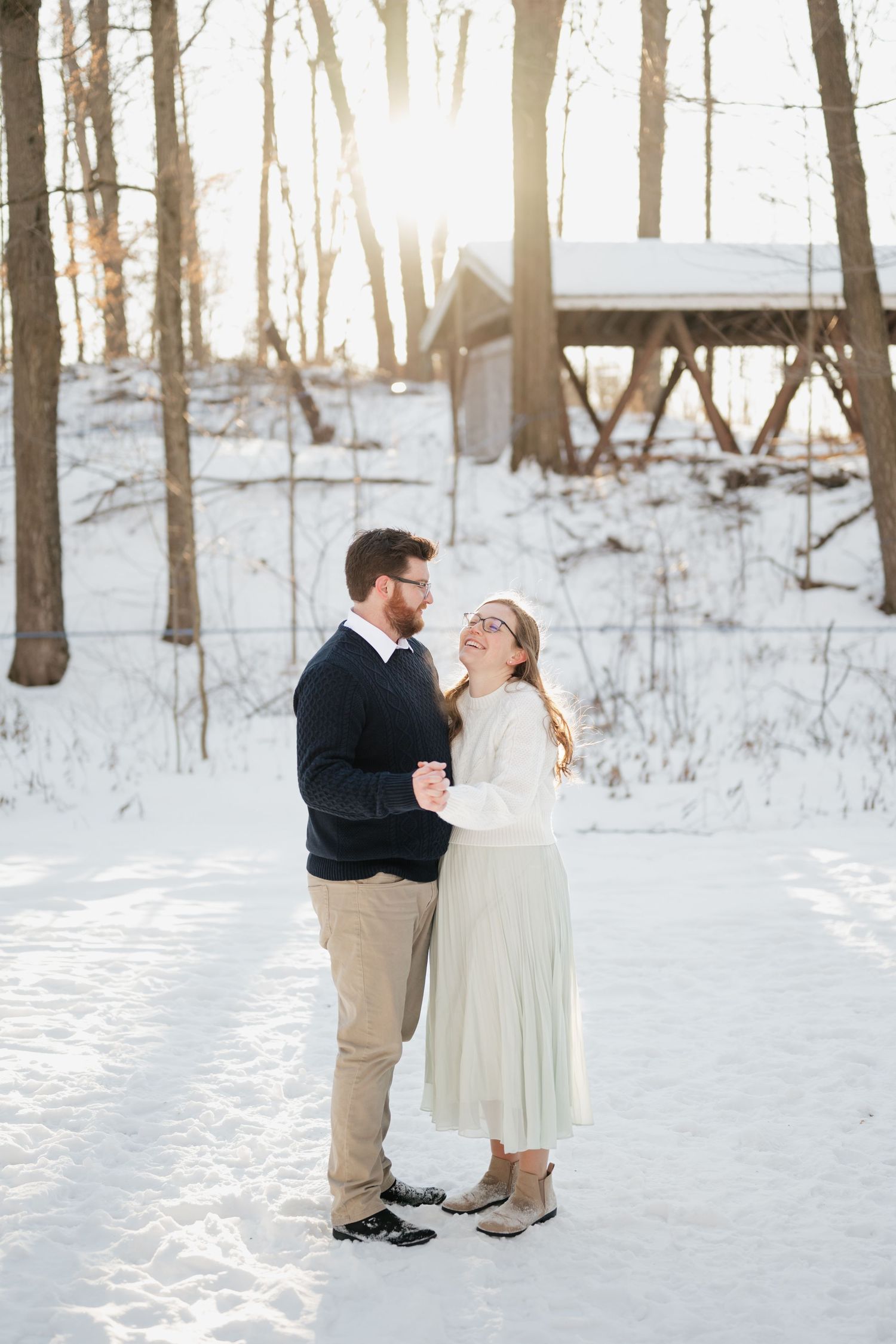 Couple smiling at eachother in Purple woods engagement shoot Port Perry Ontario
