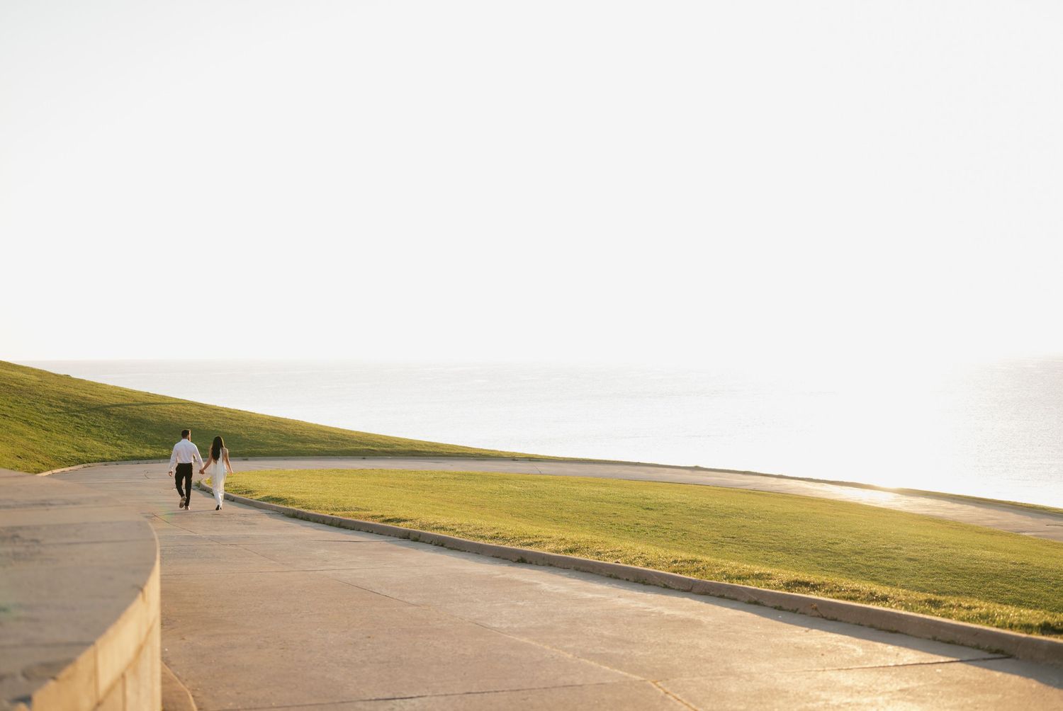 Landscape shot of a couple walking at R.C. Harris Water Treatment Plant at sunrise in Toronto