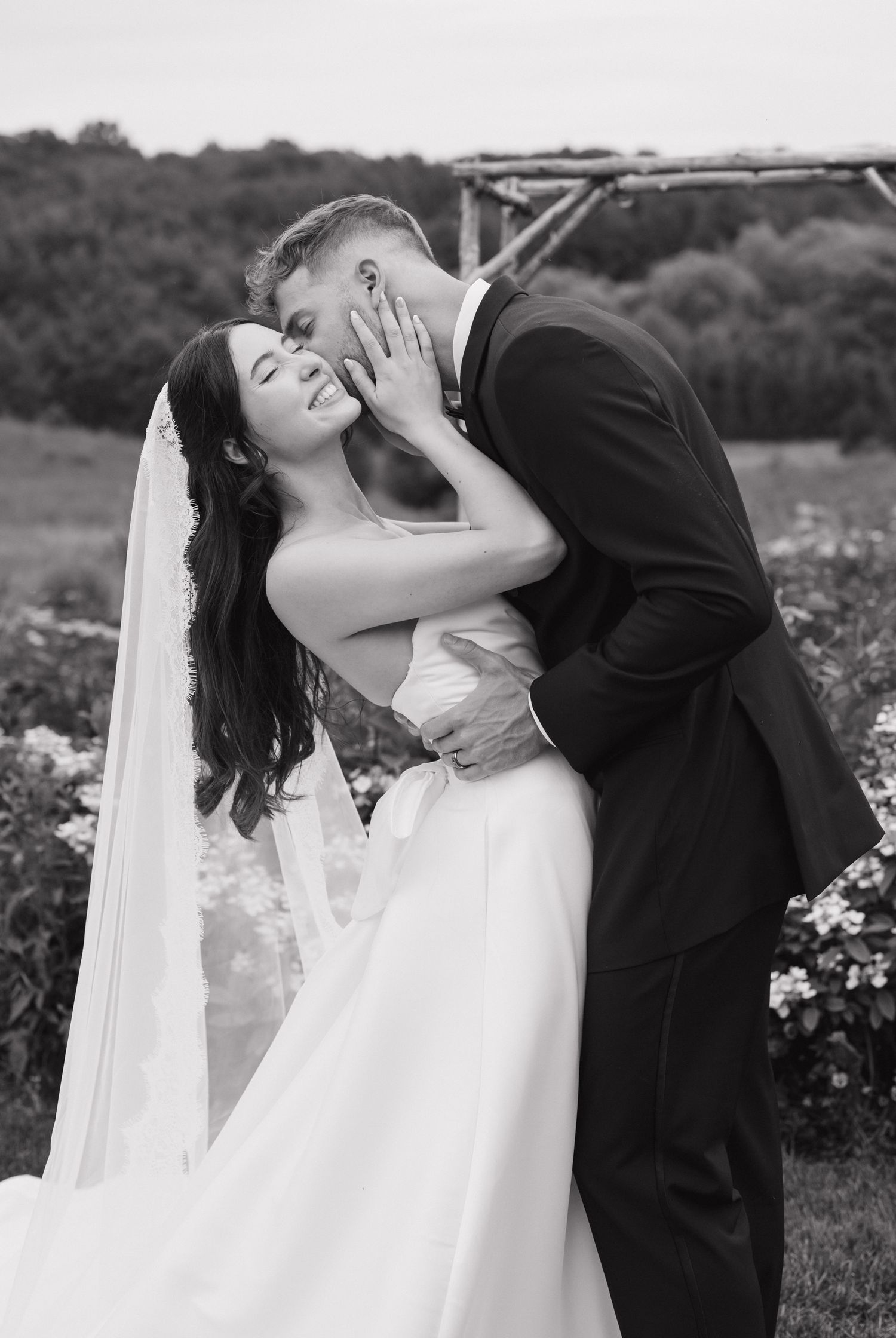 Couple kissing at country cut flowers in newmarket