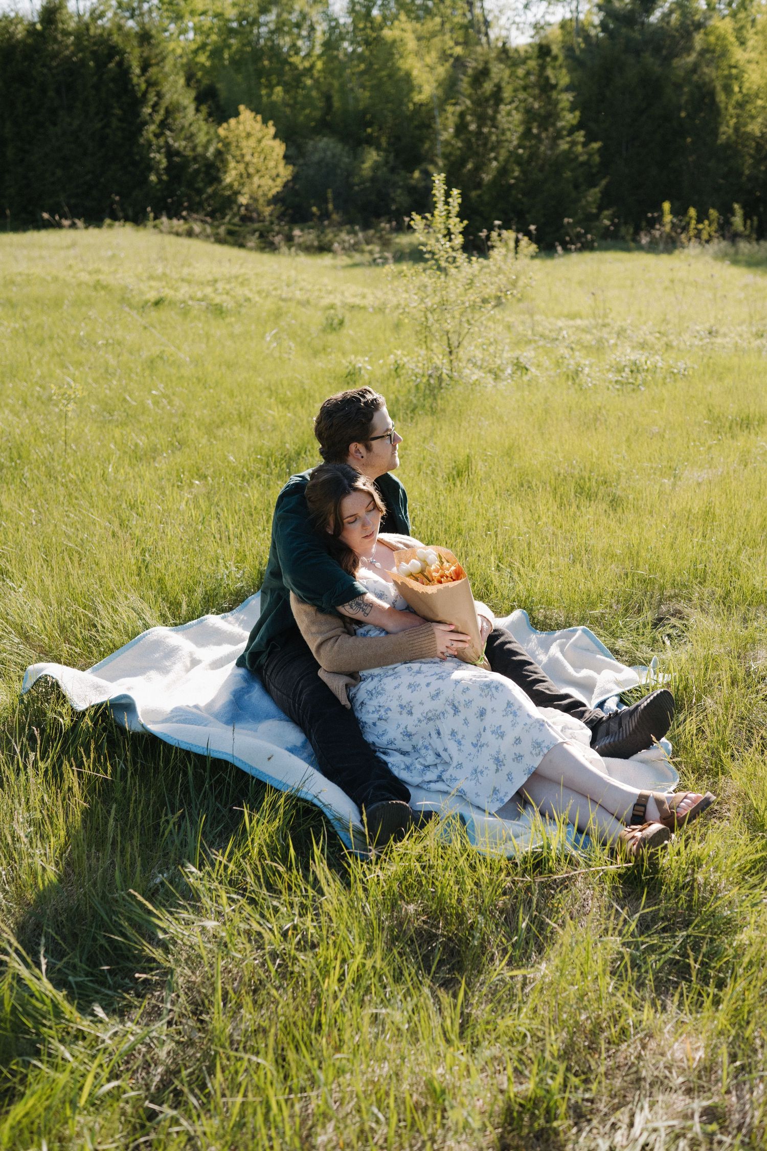 Couples portrait during engagement shoot in Field in Uxbridge ON