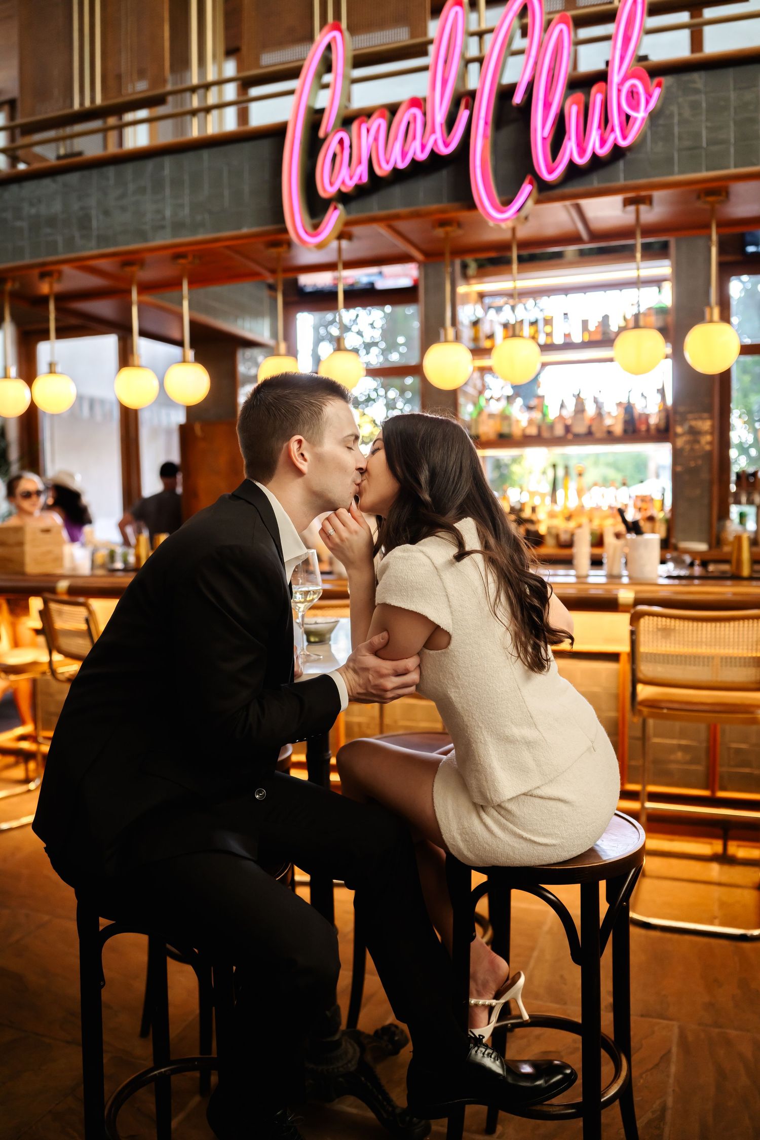 Romantic moment at Canal Club bar with pink neon lighting and warm ambient atmosphere.