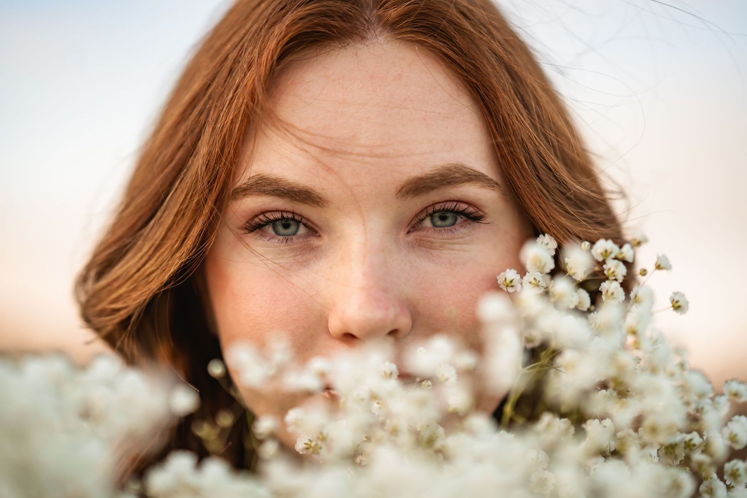 Close up portrait with delicate white baby's breath flowers in soft natural lighting.