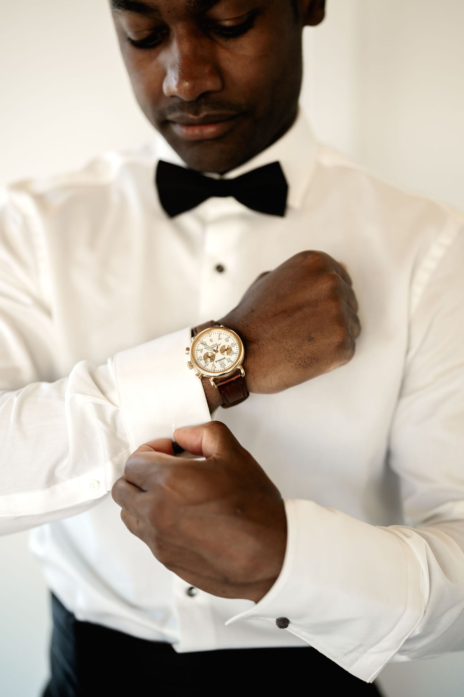 Close-up shots of hands adjusting cufflinks and formal wear accessories.