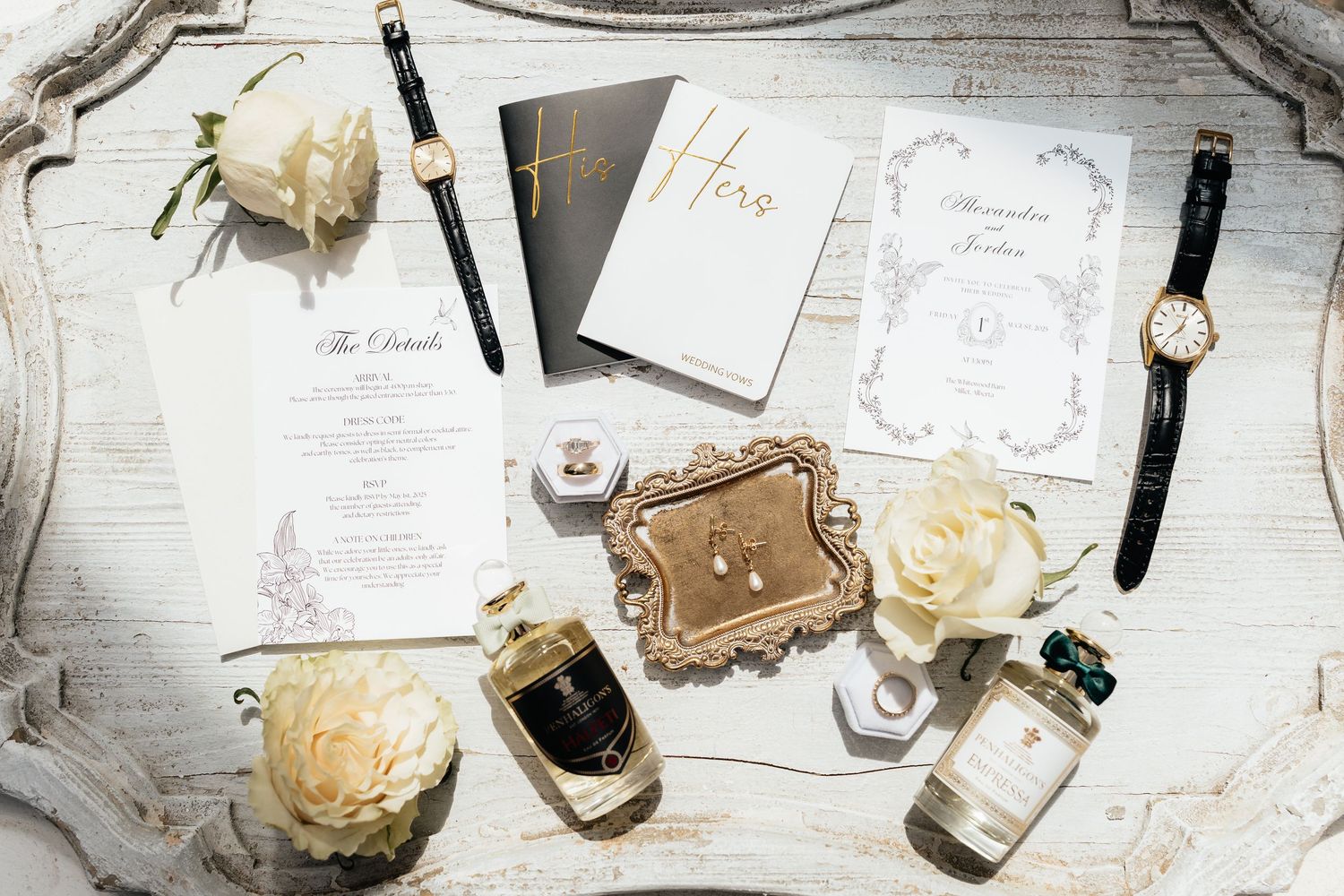 Wedding stationery and rose flatlay on white wooden background with vintage details.