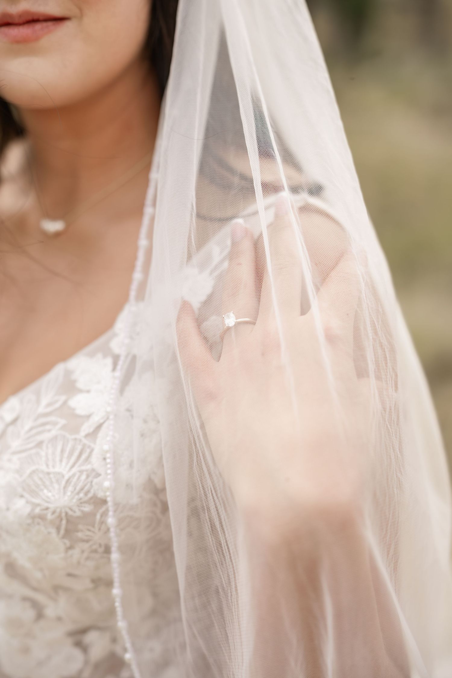 A romantic and ethereal bridal portrait series showing a delicate white veil with soft lighting and shallow depth of field.