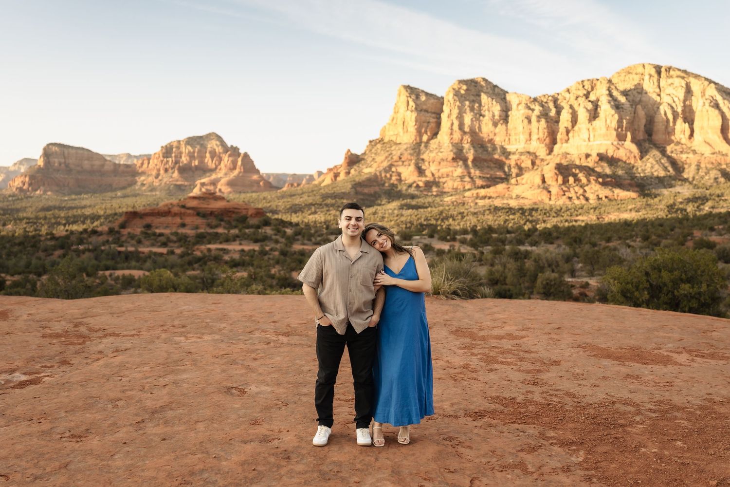 Desert engagement photos with dramatic rock formations and golden evening light.