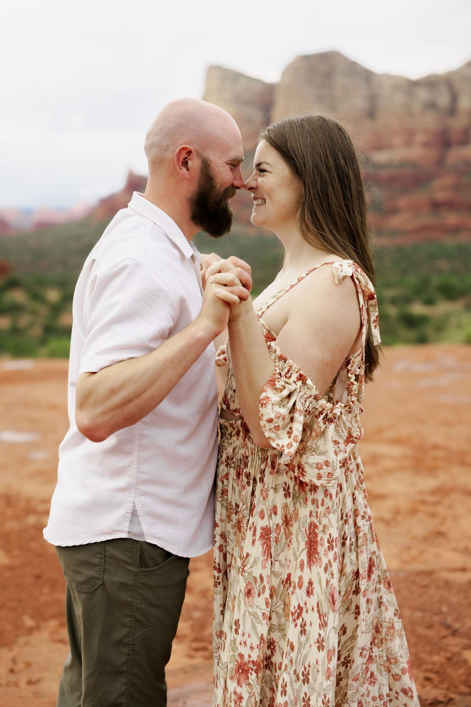 Intimate couple portraits captured against stunning desert landscape.