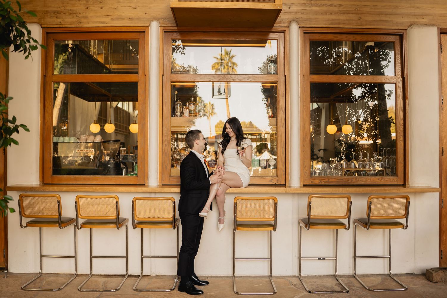 Interior hallway with framed artwork and golden lighting for wedding venue.