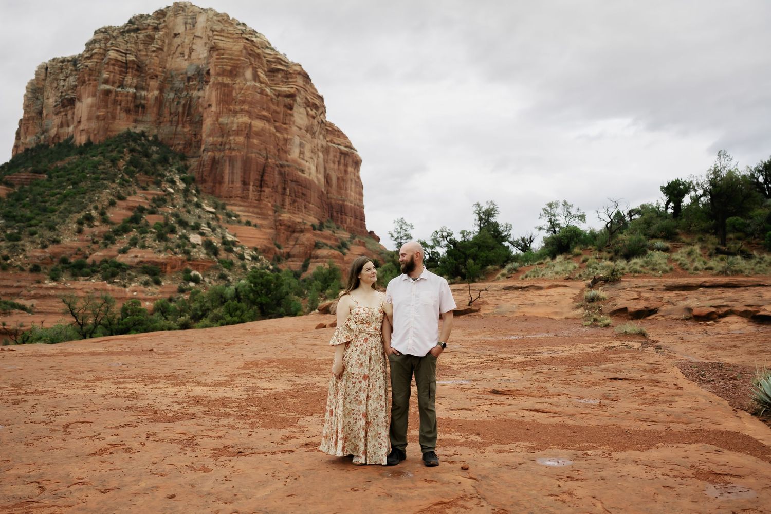 Wide landscape shots of a couple among majestic red rock formations in Arizona.